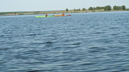 Two Kayakers Rowing on Lake