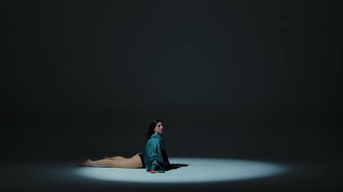 Charming Brunette Dancing Modern Contemporary Choreography on a Dark Gray Studio Background