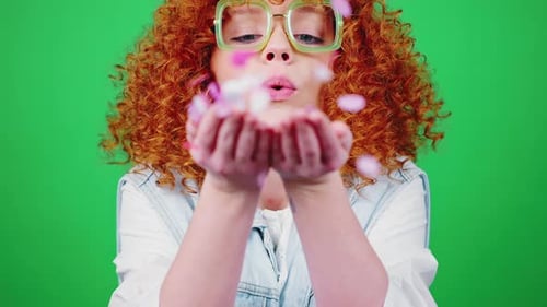 Young Happy Woman Blowing Colorful Confetti to Camera and Smiling Green Chroma Key Background Slow