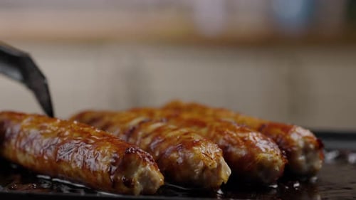 Sizzling Sausages Cooking on a Hot Grill
