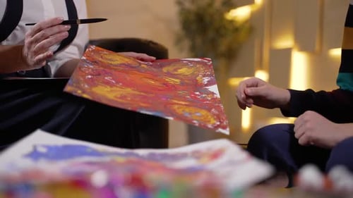 Woman and Child Discussing Art Indoors