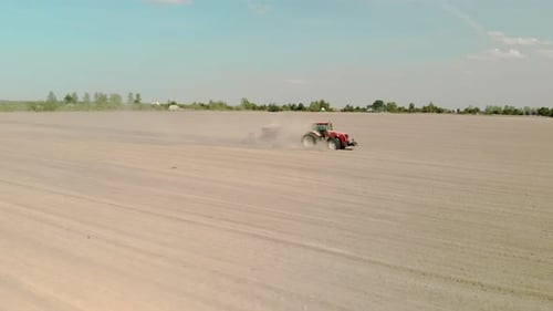 Tractor Plowing Field in Rural Setting