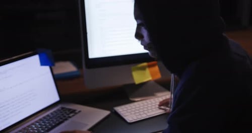 Businesswoman working in a modern office by night