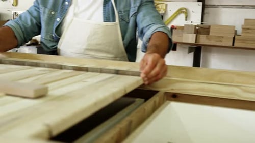 Man Working with Wood in Workshop