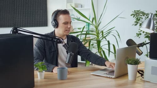 Man Recording Podcast With Laptop At Home