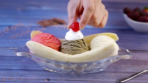 Preparing Delicious Banana Split with Cherry Topping