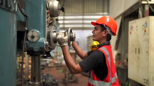 Industrial engineer worker operating control panel system at manufacture plant