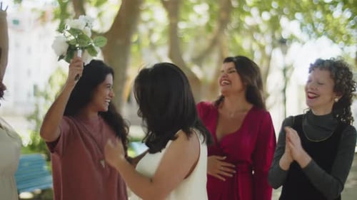 Beautiful Lesbians Celebrating Wedding with Friends in Park