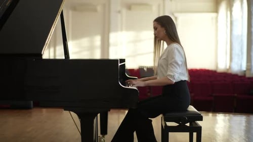 Side View of Female Pianist Wearing Elegant Clothes Playing Gentle Classical Music on Royal Piano on