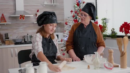 Grandmother and Granddaughter Baking Christmas Cookies Together