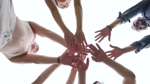Group of People Putting Hands Together for Teamwork