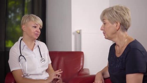 Doctor and Patient Speaking in Medical Office