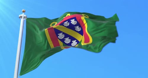 Green Flag with Heraldic Coat of Arms Waving in Blue Sky