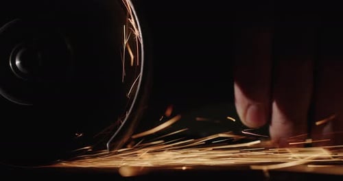 Grinding Metal Creates Bright Sparks at Night