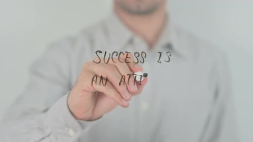 Success Is An Attitude Writing on Screen with Hand