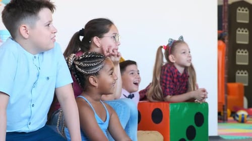 Excited Children and Young Adult Watching Something