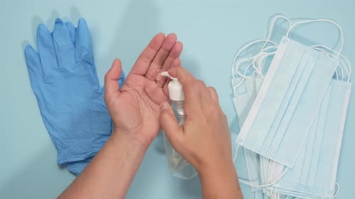 woman disinfects her hands with antiseptic
