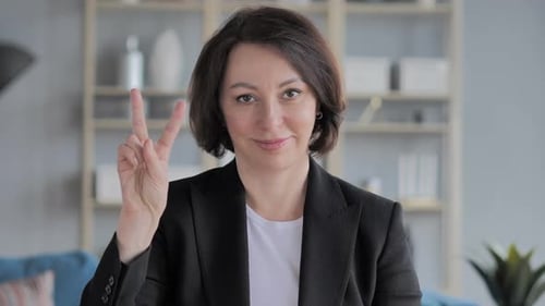 Mature Woman Makes Peace Sign Gesture