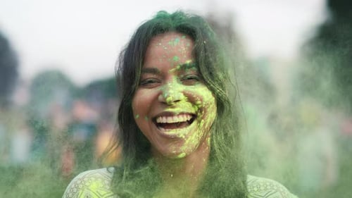 Close up of multiracial woman looking at camera at holi festival. Shot with RED helium camera in 8K.