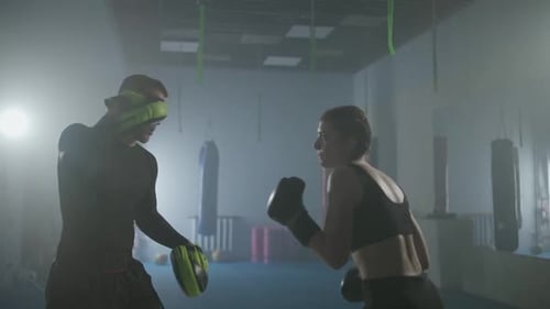 Female Fighter Trains His Fast Punches Punching Focus Mitts Training Day with a Coach in Boxing Gym