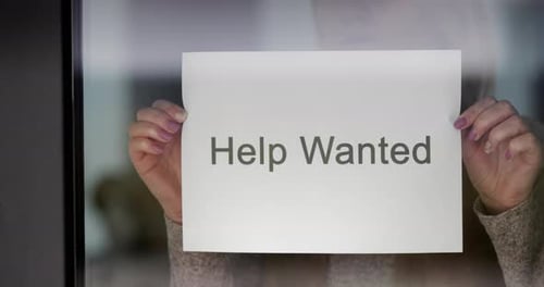 Employee Hangs on the Door Ad Help Wanted