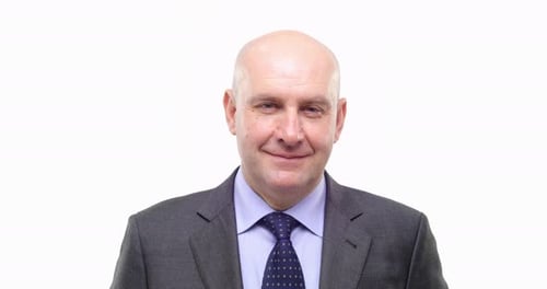 Smiling Man in Suit with Patterned Tie