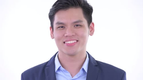 Face of Happy Young Asian Businessman Smiling
