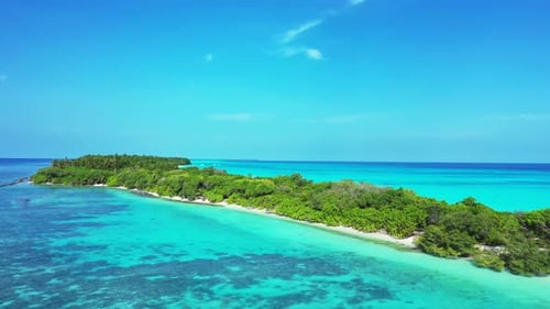 Wide angle flying travel shot of a white paradise beach and blue water background in vibrant 4K