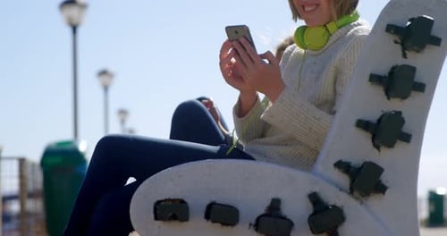 Adolescente con teléfono móvil en la playa 4k