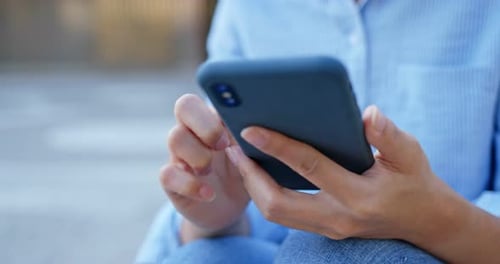 Young Adult Using Mobile Phone in Urban Setting