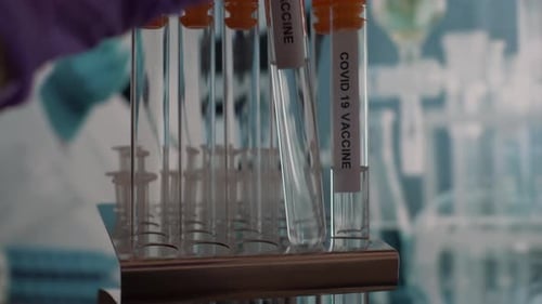 Coronavirus Covid 19 Test Tube Vials Being Placed Into Rack. Close Up, Locked Off