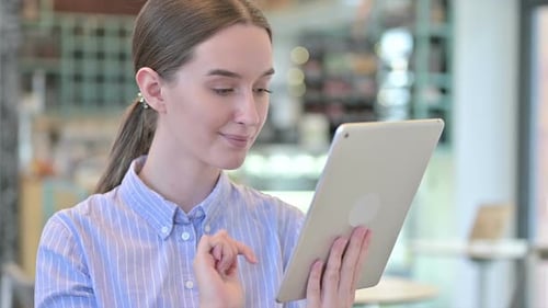 Young Woman Using Tablet Device Indoors