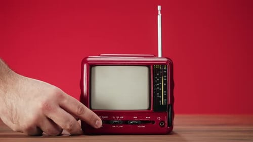 Hand Turns on Retro Red Television