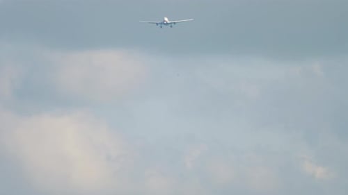 Commercial Airplane Approaching for Landing on Cloudy Day