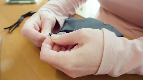 Close Up of Hands Sewing Face Mask