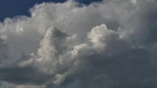 Drifting Clouds Against Vibrant Blue Sky