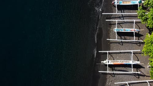 Top Down View on Boats on Black Sand Beach