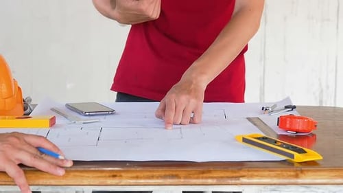 Architect discuss with engineer about project in construction site