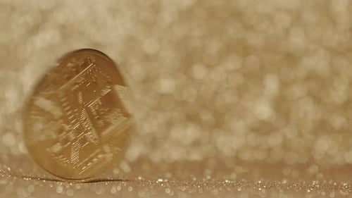 Bitcoin Spins on a Gold Glittering Surface