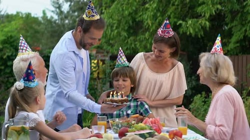Family Celebrates Boy's Birthday in Garden