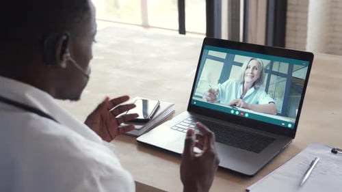 Man Has Online Video Call with Patient on Laptop