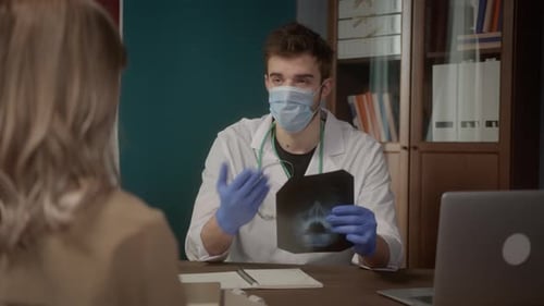 Professional Doctor Wearing Medical Mask Consulting Young Woman Looking at Xray Consultation and