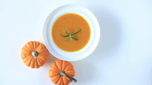 Pumpkin soup and pumpkin on a table. Top view