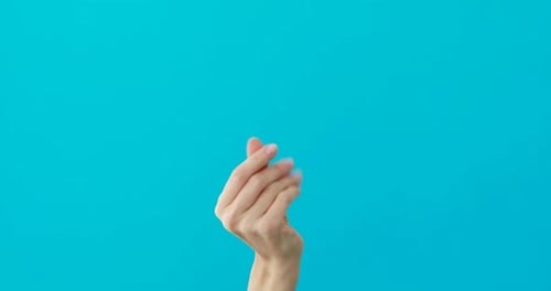 Isolated Hand Snaps Fingers on Teal Backdrop