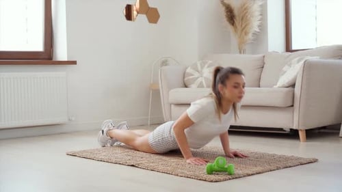 Woman Exercising Doing Push-ups in Her Living Room