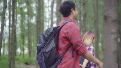 Hiker Asia backpacker couple adventure feeling freedom walking in forest, enjoy their holidays.