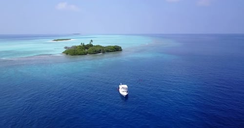 Daytime birds eye tourism shot of a white paradise beach and aqua turquoise water background