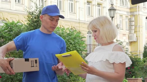 Delivery Man Giving Package to Smiling Woman