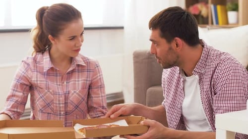 Couple Enjoys Pizza Together at Home