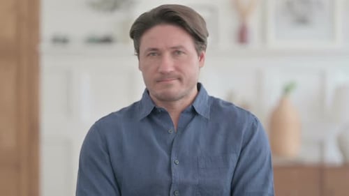 Man Looks Worried Indoors Wearing a Shirt